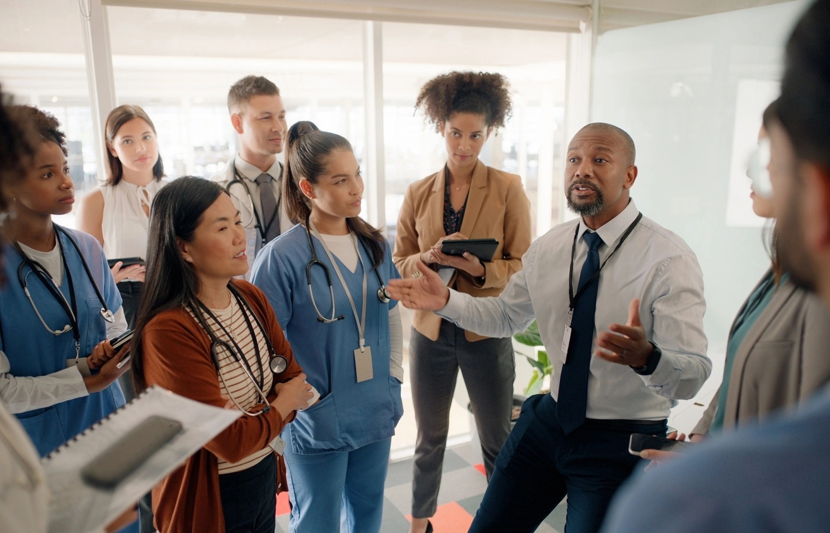 Medical team members in a group talking with each other.